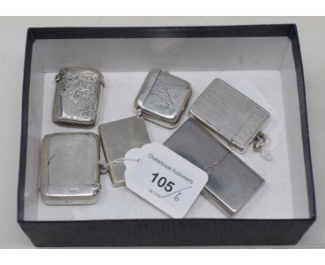 A silver vesta case, with engine turned decoration, monogrammed, Birmingham 1898, two other silver vesta cases, a silver tabl