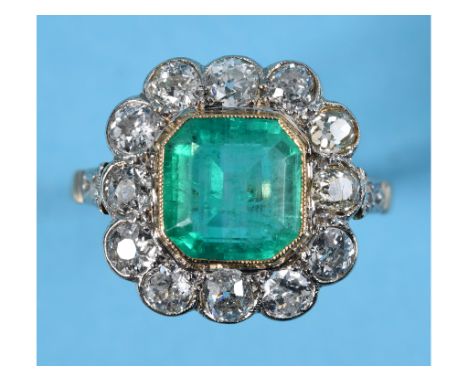 A yellow gold ring, set an octagonal cut emerald of approx. 2.65ct within a surround of old and rose cut diamonds, with Gemol