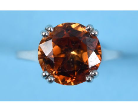 An 18ct white gold and orange zircon solitaire ring, approx. ring size N  See colour illustrationReport by RBApprox. 6.9 g 