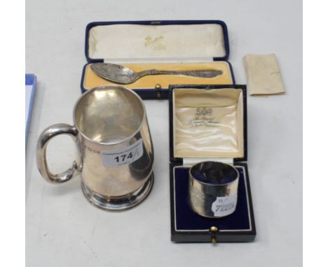 A silver mug, of baluster form, monogrammed and dated, London 1930, a silver napkin ring, and a silver commemorative spoon, a