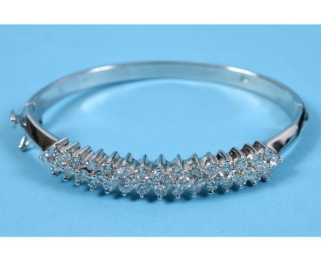 A white gold and diamond set bangle, with approx. 4.6ct of diamonds  See illustration 