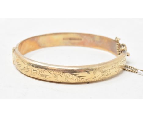 EXTRA LOT: A 9ct gold bangle, with engraved decoration, approx. 13.1 g 
