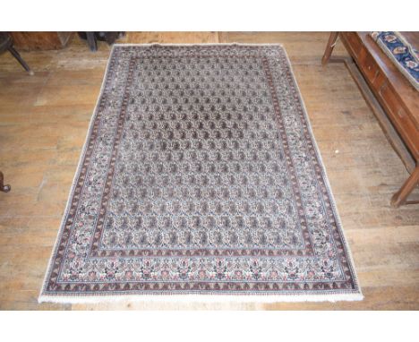 A Persian Moud carpet, decorated paisley motifs on a cream ground, within a multi border, 310 x 216 cmStructurally in good sh