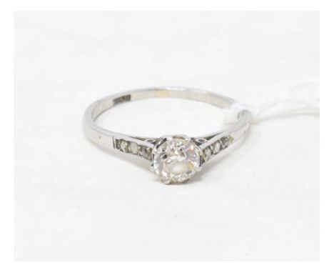 A platinum and solitaire diamond ring, with six small diamonds to the shoulders, approx. ring size Q 