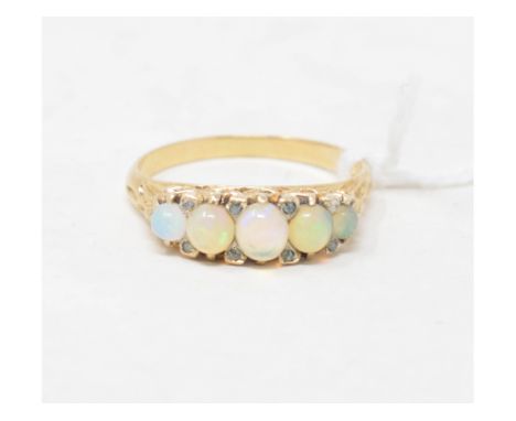 A gold ring, set opals interspersed by diamond chips, approx. ring size P, apparently unmarked 