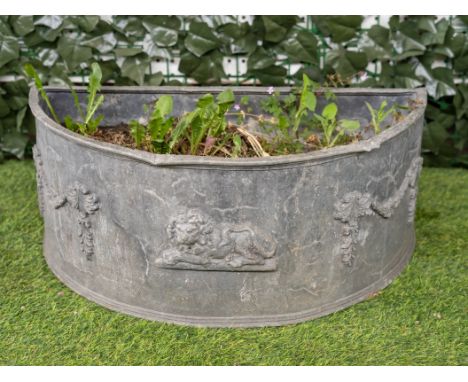 A LEAD FLORAL SWAG CAST SEMI-ELLIPTIC PLANTER60cm wide; 30cm deep; 25cm high