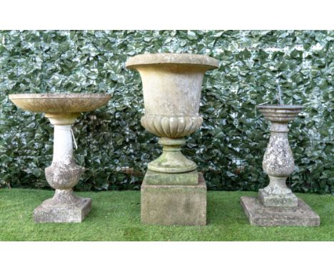 A RECONSTITUTED STONE CIRCULAR BIRD BATH (3)55cm diameter; 70cm high, together with a reconstituted stone sundial, 73cm high 