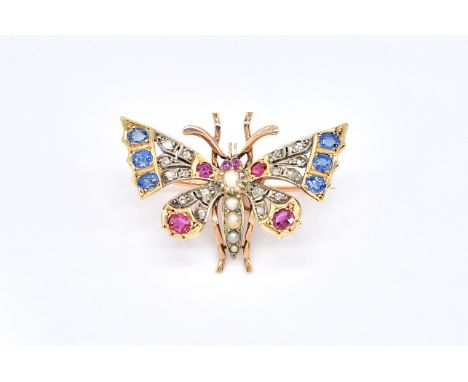 A DIAMOND, RUBY, SAPPHIRE AND HALF PEARL SET BUTTERFLY BROOCHThe body mounted with a row of half pearls, the wings mounted wi