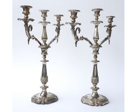 TWO VICTORIAN PLATED CANDELABRA (2)Each central stand with acanthus and scrolling decoration, both tops with currently three 