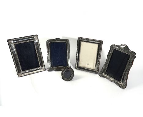 FIVE SILVER MOUNTED PHOTOGRAPH FRAMES (5)Comprising; a shaped rectangular frame, of Art Nouveau inspired design, Birmingham 1