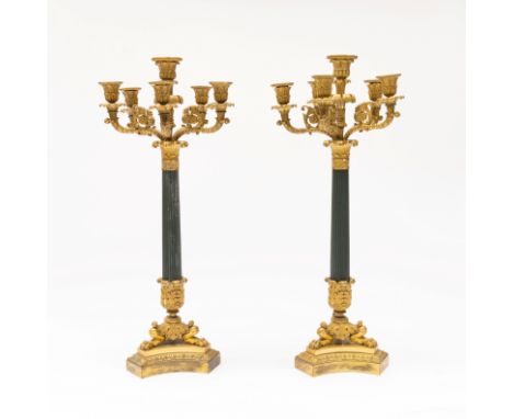A PAIR OF RESTAURATION GILT AND PATINATED BRONZE SIX-LIGHT CANDELABRA (2)Each fluted column with acanthus leaf and lions’ paw