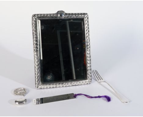 A SILVER FRAMED MIRROR AND FOUR FURTHER SILVER ITEMS (5)The silver framed mirror of shaped rectangular form, with curved flut