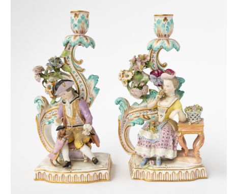 A PAIR OF ENGLISH PORCELAIN CANDLESTICK FIGURES (2)19th centuryThe figures after Meissen originals as a young man seated with