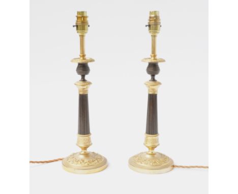 A PAIR OF FRENCH RESTAURATION STYLE GILT BRONZE TABLE LAMPS (2)Late 20th CenturyWith fluted tapering columns, on bases cast w