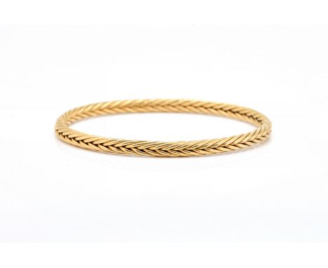 A 9CT GOLD BANGLEIn an oval multiple wirework design, weight 28.8 gmsCondition report;Interior diameter of bangle 7.4cm x 6.5