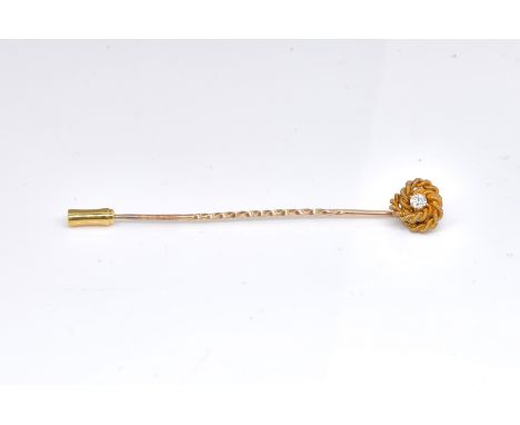 A GOLD AND DIAMOND TIE PIN / STICK PINClaw set with a diamond within a rope-work surround, detailed 12ct, length 6.5cm, gross