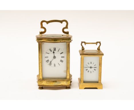 A FRENCH BRASS CASED CARRIAGE CLOCK AND ANOTHER SMALLER CARRIAGE CLOCK (2)Both with Roman numeral our markers on enamel dials