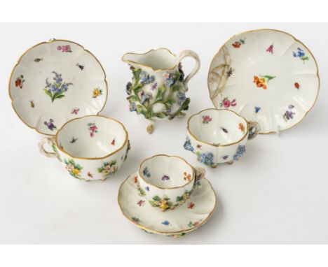 A MEISSEN FLOWER ENCRUSTED MILK JUG, THREE CUPS AND SAUCERS (7)Late 19th centuryEach applied with flowers and painted with fl