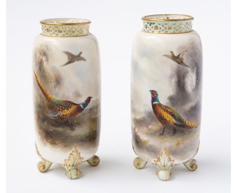 A PAIR OF ROYAL WORCESTER VASES (2)Circa 1903Cylindrical with pierced rims, each painted by James Stinton, signed, with a phe