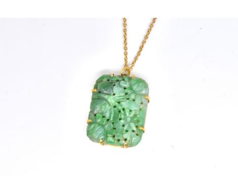 A GOLD AND JADE PENDANT WITH A GOLD NECKCHAIN (2)The rectangular pendant carved and pierced with flowers and foliage, on a tr