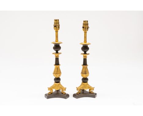 A PAIR OF FRENCH RESTAURATION STYLE GILT AND PATINATED BRONZE TABLE LAMPS (2)20th CenturyWith acanthus leaf clasped and flute