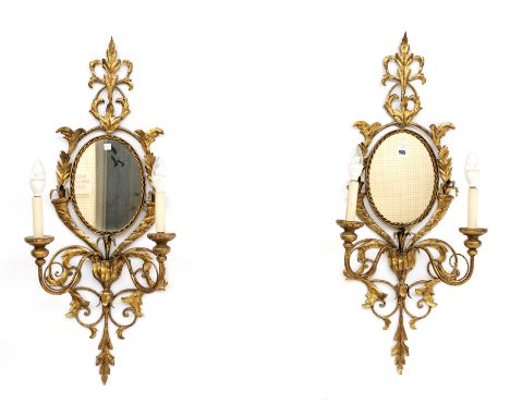 A PAIR OF OVAL GOLD PAINTED METAL TWIN LIGHT GIRANDOLE MIRRORS (2)40cm wide; 93cm high