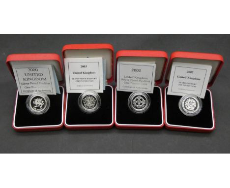 Four one pound silver proof Piedfort pound coins. All in red leather presentation cases with COA's. Including 2000, 2001, 200