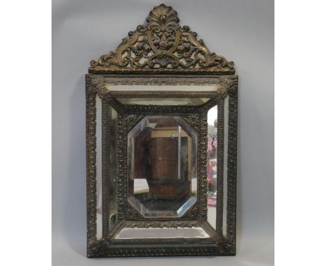 A 19th century Dutch brass framed repousse cushion mirror with scrolling arched cresting and original bevelled central plate.
