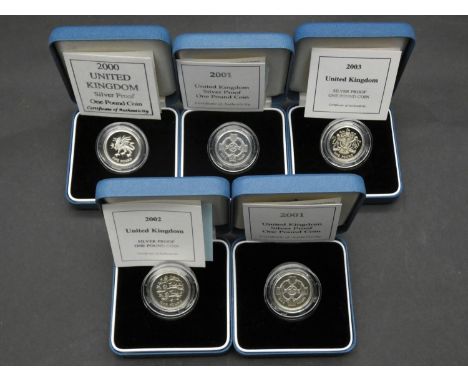 Five Royal Mint one pound silver proof coins. All in pale blue presentation cases with COA's. Including 2000, 2001, 2001, 200