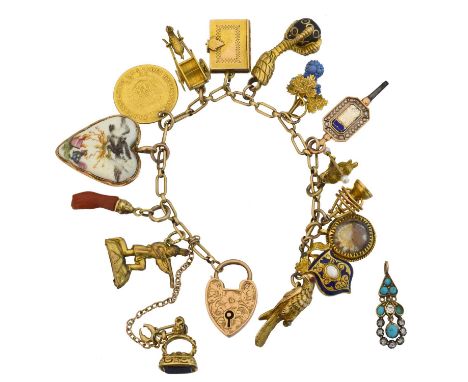 A charm bracelet.  The 9ct gold trace link chain with heart shape padlock clasp bearing hallmarks for Birmingham, 1899, suspe