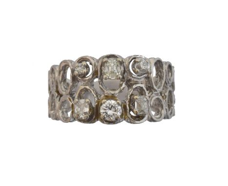 A 1960s diamond dress ring. Designed as a series of vari cut diamonds atop the textured, openwork band, stamped 18ct, ring si