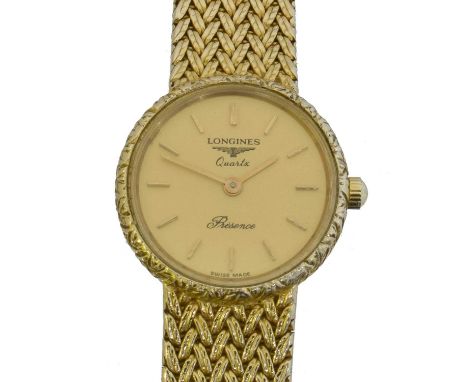 A 9ct gold Longines Presence quartz wristwatch, ref. 26.065.7..9.  The signed circular gold tone dial with baton markers, sig