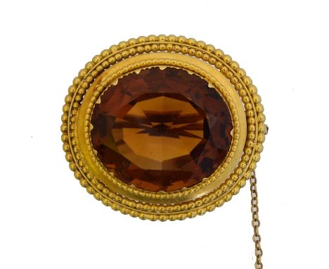 A Victorian citrine brooch. The circular shape citrine within a beaded surround, length 3.2cm, gross weight 12.1g.Overall con