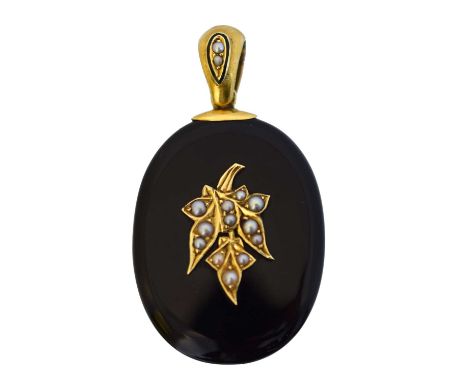 A Victorian onyx and split pearl memorial locket. The oval onyx locket set with split pearls in a foliate design, with glazed
