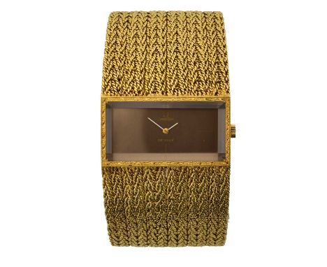 A 1970s 18ct gold Omega De Ville manual wind wristwatch, ref. 97320/8270. The brown rectangular signed dial with quarter mark
