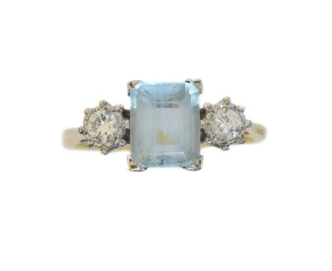 An aquamarine and diamond three stone ring. The emerald cut aquamarine weighing approx. 2cts with brilliant cut diamond sides