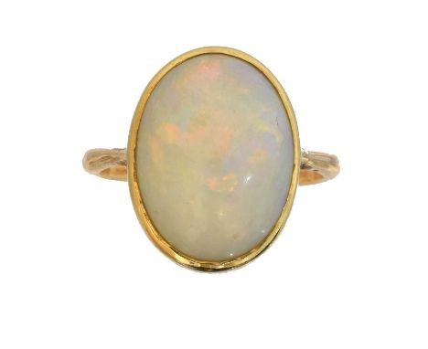 An opal single stone ring. The oval opal cabochon within a rubover setting, marks worn, ring size I1/2, gross weight 4.9g.Ove