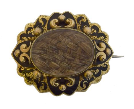 A Victorian mourning brooch. The oval hairwork panel within an enamel scrolling surround, length 4.4cm, gross weight 16.7g.
