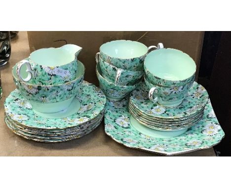 A Shelley "Marguerite" pattern green ground tea set with five cups and six saucers, six side plates, sandwich plate, cream ju