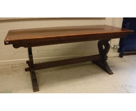 A 20th Century oak refectory style dining table, the plank top on trestle end supports united by a centre stretchers, 183 cm 