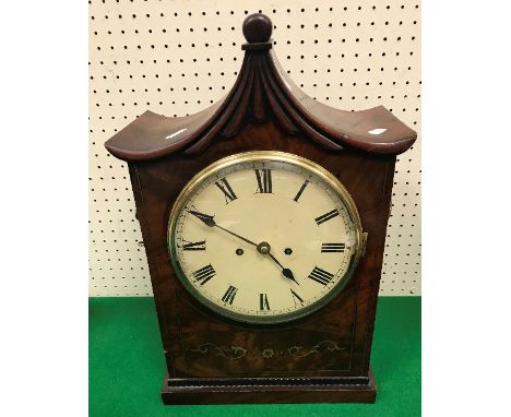 A circa 1830 mahogany and brass inlaid bracket clock, the pagoda top with moulded decoration above a figured brass inlaid fro