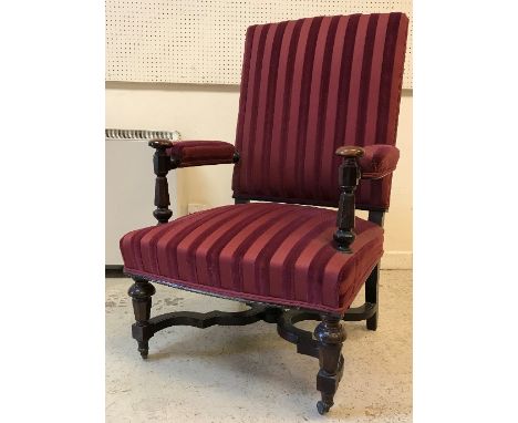 A Victorian upholstered open arm hall chair, the arms on faceted tapering octagonal supports, the seat raised on matching fac