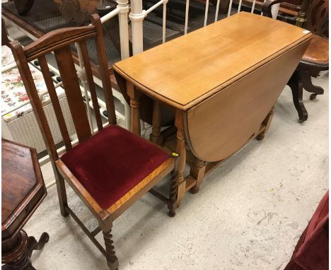An oak oval gate-leg drop-leaf dining table and set of four oak dining chairs