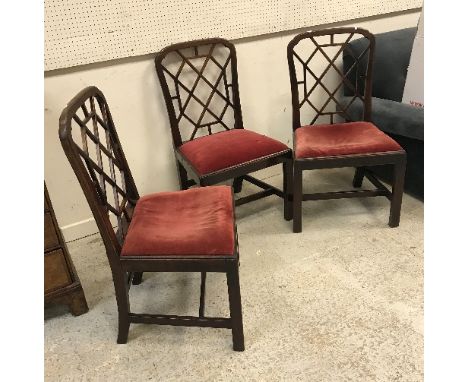 A set of three 19th Century mahogany framed dining chairs in the Chinese Chippendale taste, the latticework backs over drop i