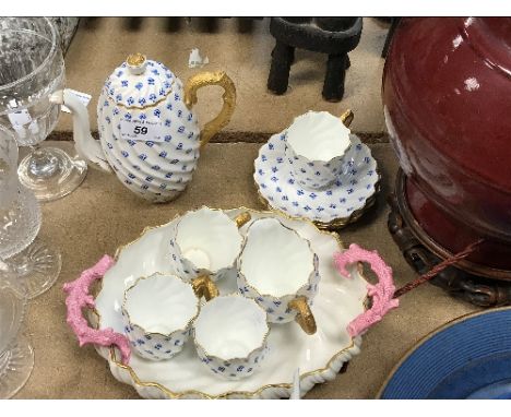 A Coalport blue floral printed and gilt decorated coffee set of writhen form with gold serpentine handles, comprising coffee 