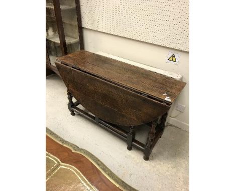 A late 17th Century oak oval gate-leg drop-leaf dining table on baluster turned and ringed supports to block feet, united by 