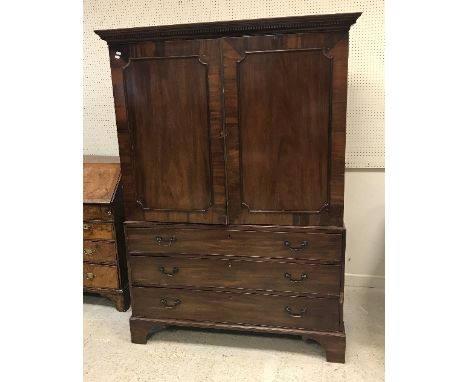 A 19th Century mahogany linen press, the moulded and dentil cornice over two panelled doors enclosing a hanging space (former