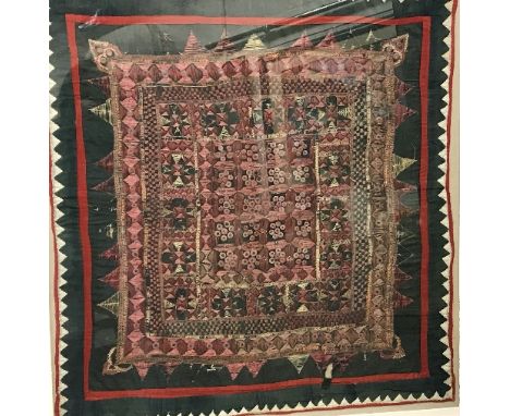 An Indian needlework panel with stylised flower head decoration to centre and applied mirrored detail, together with another 