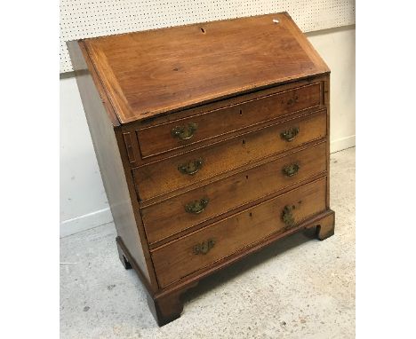 An 18th Century walnut bureau, the top boxwood strung over a sloping fall enclosing a basic fitted interior with pigeonholes 