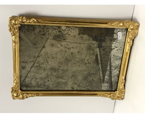 An 18th Century Vauxhall glass mirror in later gilt and gesso rectangular frame